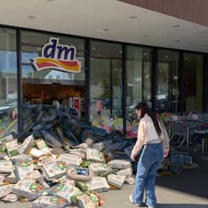Products Piled Up at the Store Entrance in a fake-out-of-home ad of DM