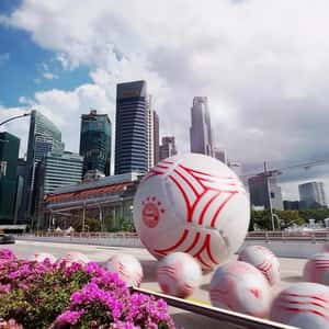 Footballs Roll Through Singapore's Landmarks in a fake-out-of-home ad of Adidas