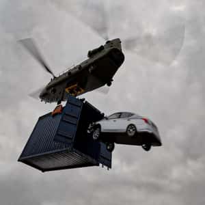 Car Jumps onto Boxship from Helicopter in a fake-out-of-home ad of Automax