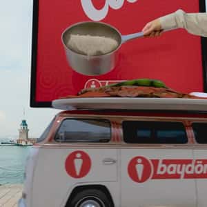Hand Pours Pan from Ad onto Dish in a fake-out-of-home ad of Baydöner