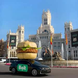 Burger Installation Above Driving Car in a fake-out-of-home ad of Bolt