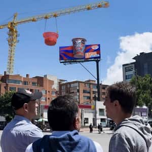 Crane Pours Cereal onto Yogurt Billboard in a fake-out-of-home ad of Bon Yurt Alpina