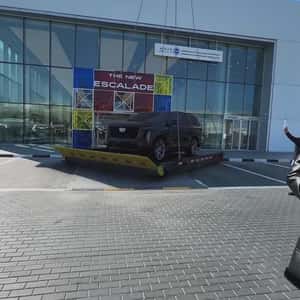 Helicopter Transports Car Outside Showroom in a fake-out-of-home ad of Cadillac
