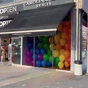 Rainbow Balloons Rising from Store in a fake-out-of-home ad of Carolina Lemke