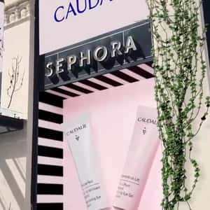 Grapes Spill Out of Window Display in a fake-out-of-home ad of Caudalie