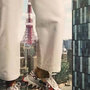 Giant in Sneakers on the Street in a fake-out-of-home ad of Christian Louboutin