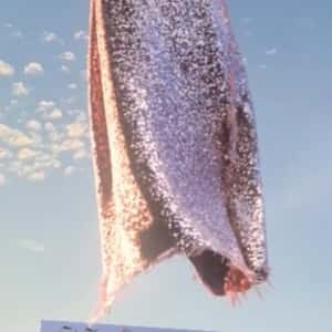 Helicopters Carry Shimmering Dress in a fake-out-of-home ad of Cinq à Sept