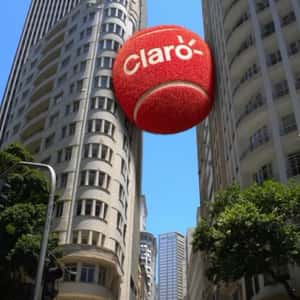 Red Tennis Ball Wedged Between Buildings in a fake-out-of-home ad of Claro
