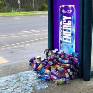 Energy Drink Cans Emerges from Ad in a fake-out-of-home ad of Elite Supps Australia
