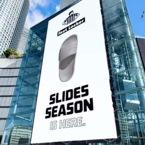 Sandals Burst Out from Digital Screen in a fake-out-of-home ad of Foot Locker