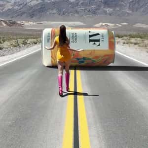 Woman Chasing Cocktail Can in a fake-out-of-home ad of Free AF