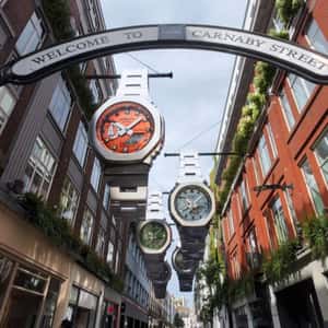 Watches Hang Above a Shopping Street in a fake-out-of-home ad of G-SHOCK