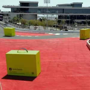 Delivery Boxes Racing on Track in a fake-out-of-home ad of Gold Apple