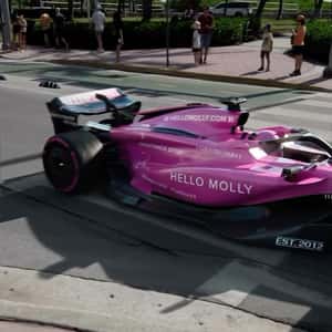 Cruising Pink-themed Formula-1 Car in a fake-out-of-home ad of Hello Molly