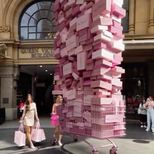 Overloaded Cart with Pink Boxes in a fake-out-of-home ad of Hello Molly