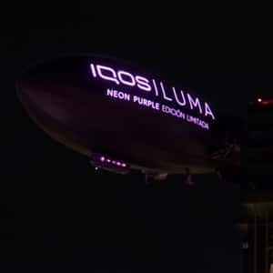 Tobacco Devices Emerges from Window Display in a fake-out-of-home ad of IQOS