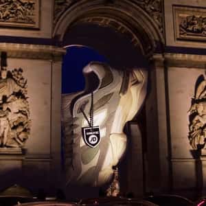 Sneaker Stuck on Arc de Triomphe in a fake-out-of-home ad of JD Sports