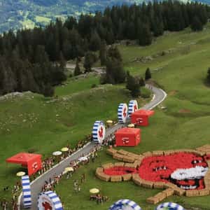 Cheese Wheels Roll on Road in a fake-out-of-home ad of La Vache qui Rit