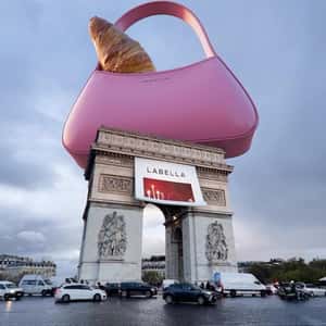 Croissant Peeking from Handbag in a fake-out-of-home ad of Labella