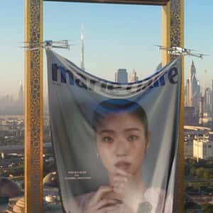 Drones Lift Magazine Cover Banner in a fake-out-of-home ad of Marie Claire