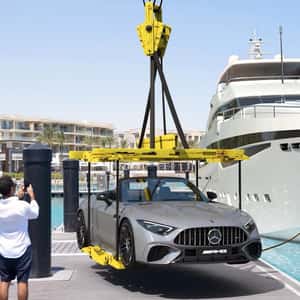 Crane Lifts Car Off Yacht in a fake-out-of-home ad of Mercedes-Benz Crane