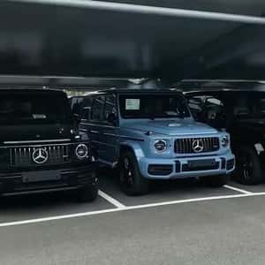 SUVs Parked Under Glass Street in a fake-out-of-home ad of [brand]