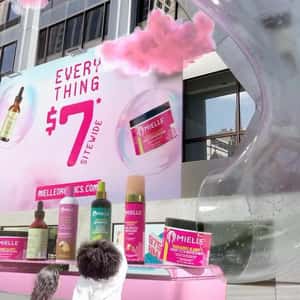 Products Slide Up from Conveyor in a fake-out-of-home ad of Mielle Organics