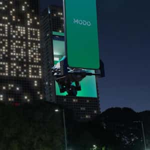 Phone Reads Window QR Lights in a fake-out-of-home ad of MODO