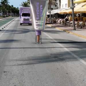 Truck Smashes Sunscreen to Pieces in a fake-out-of-home ad of Naked Sundays