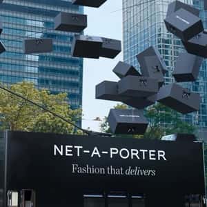 Double-decker Bus Unloads Black Boxes in a fake-out-of-home ad of NET-A-PORTER