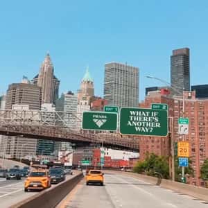 Brand Signage Hangs Above Highway in a fake-out-of-home ad of Prada Beauty