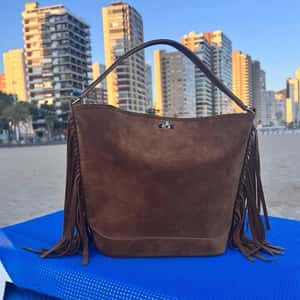 Bag Rising from the Sand in a fake-out-of-home ad of Sandro Paris