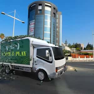 Truck Loaded with Tennis Balls in a fake-out-of-home ad of Green Padel Club