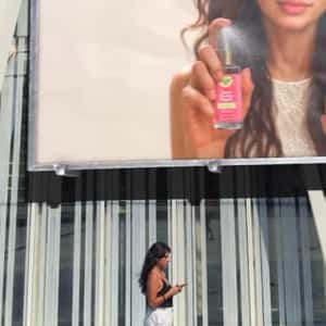 Hair Oil Sprays from Billboard in a fake-out-of-home ad of OGX Beauty