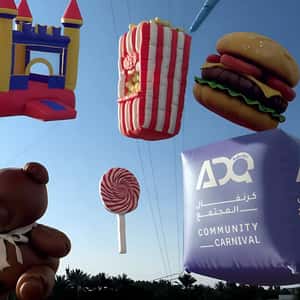 Colorful Inflatables Floats at Park in a fake-out-of-home ad of ADQ Community