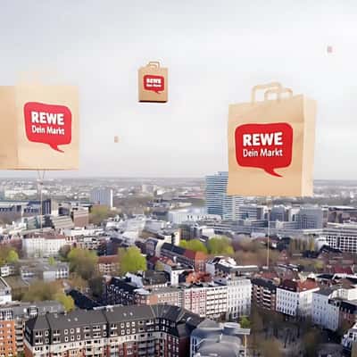 Grocery Paper Bags Floats in a fake-out-of-home ad of REWE
