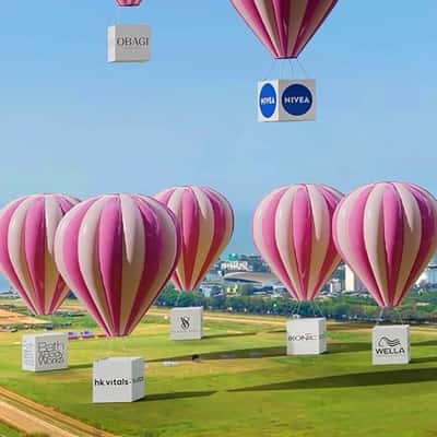 Parachute with Branded Boxes Descend in a fake-out-of-home ad of Nykaa