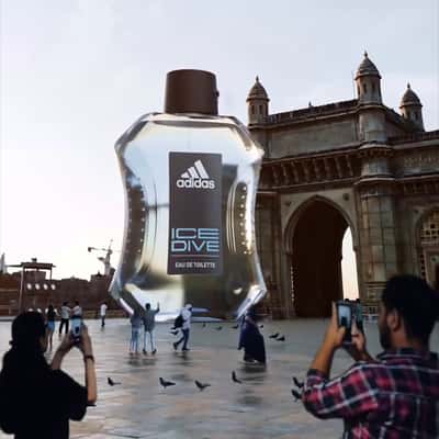 Man Climbs at Perfume Bottle in a fake-out-of-home ad of Nykaa
