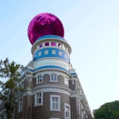 Pink Disco Ball Rolls Above the Building in a fake-out-of-home ad of Nykaa