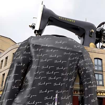 Sewing Machine Stitches Leather Jacket in a fake-out-of-home ad of AllSaints