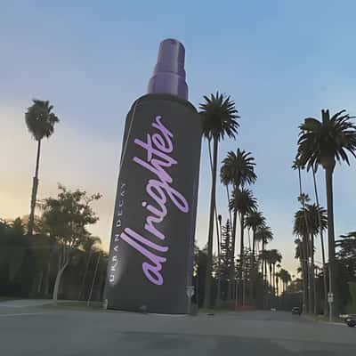 Setting Spray Stands Along Palm Trees in a fake-out-of-home ad of Urban Decay