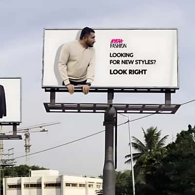 Man Crossing Through Billboards in a fake-out-of-home ad of Nykaa Fashion