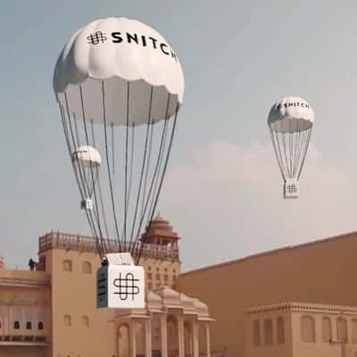 Parachutes Pull Off Red Cloth of Store in a fake-out-of-home ad of Snitch