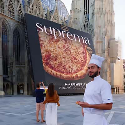 Pizza Box Leaning on the Church in a fake-out-of-home ad of Dr. Oetker