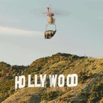 Helicopter with Banner Soars Above Hollywood in a fake-out-of-home ad of LA GOLF