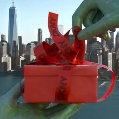 Statue of Liberty Unwraps Gift Box n a fake-out-of-home ad of DKNY