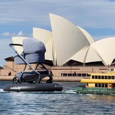 Ferry Pulling a Stroller on Inflatable in a fake-out-of-home ad of Redsbaby