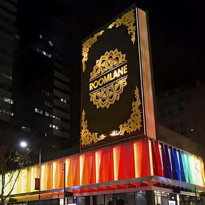Book Flips Open Above the Roof in a fake-out-of-home ad of Room Lane Furniture