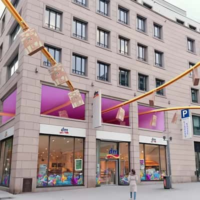 Shopping Bags Gliding on the Conveyor in a fake-out-of-home ad of DM