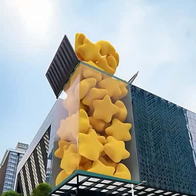 Plush Stars Floats at the Building in a fake-out-of-home ad of Starbucks